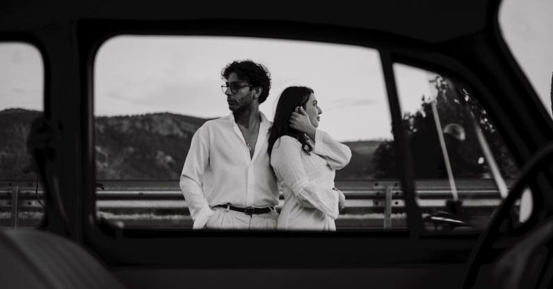 Car Models - Woman and Man Standing behind Car Window