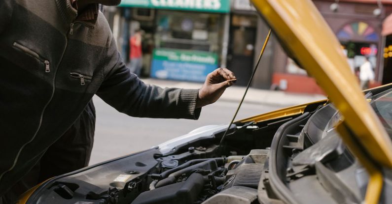 Engine Problems - Ethnic mechanic changing detail in car engine