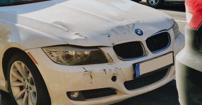 Car Dents - Damaged Front of A White Car