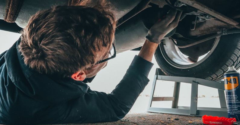 Car Maintenance - Man Fixing Vehicle Engine