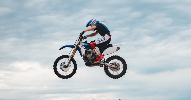 Off-Road Performance - Unrecognizable biker doing trick in air