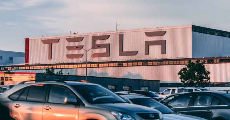 Electric Vehicles - Cars Parked In Front Of Company Building