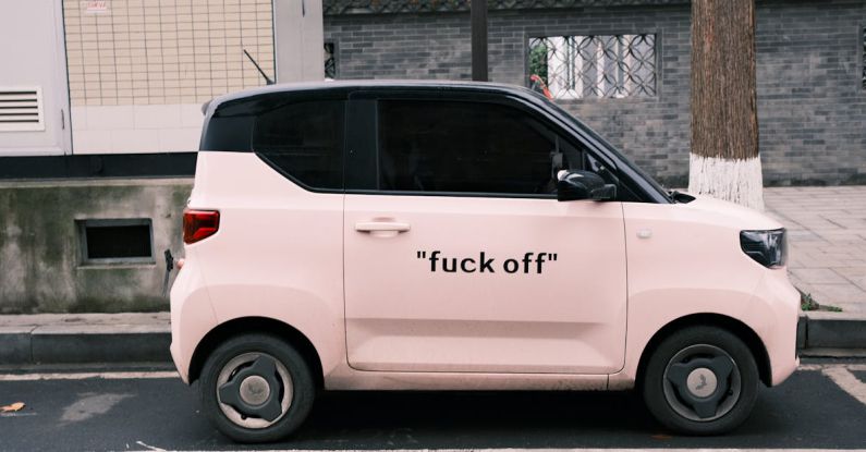 EVs - A pink car with the words luck off on it