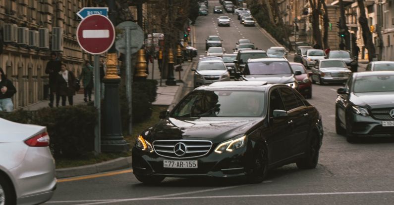 Eco-Driving - A car driving down a city street with other cars