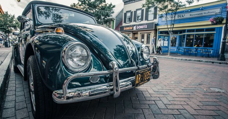 Green Car Technologies - Green Volkswagen Beetle Parked on Sidwalk