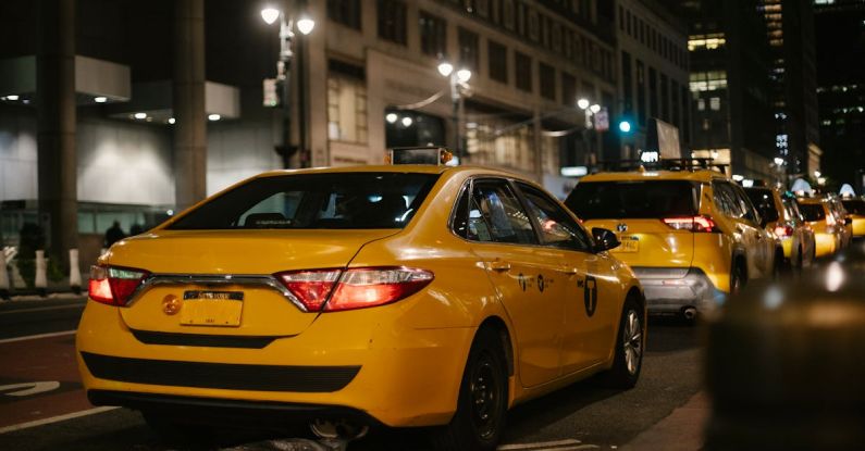 Sedan Vs. SUV - Yellow cabs driving along road at night