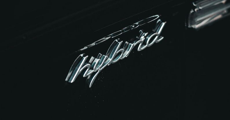 Electric Vs. Hybrid - From above of contemporary black hybrid auto with creative title and water droplets on surface