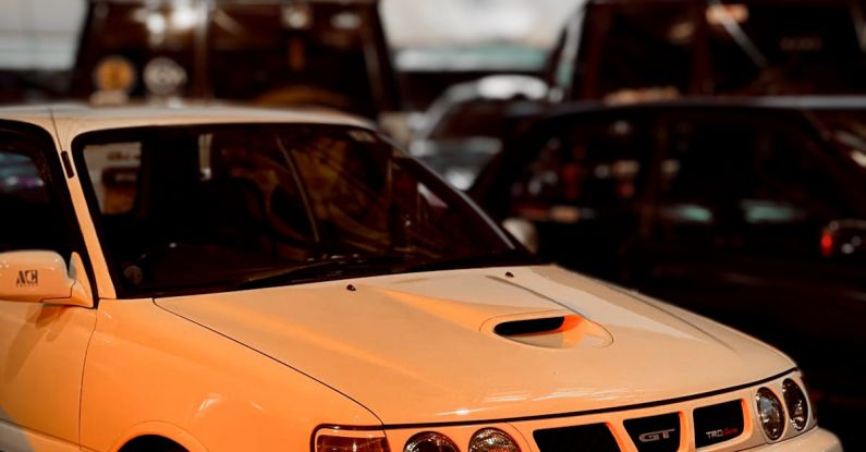 Auto Shows - A white car parked in front of a crowd