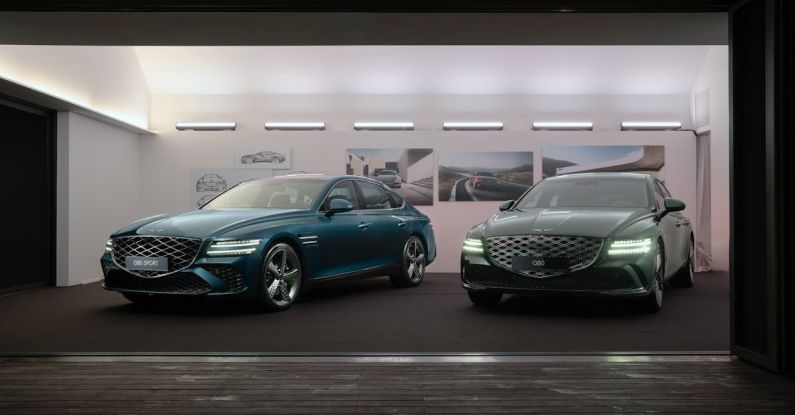 Auto Shows - The Genesis G80 and Genesis G80 Sport standing inside an exhibition booth.