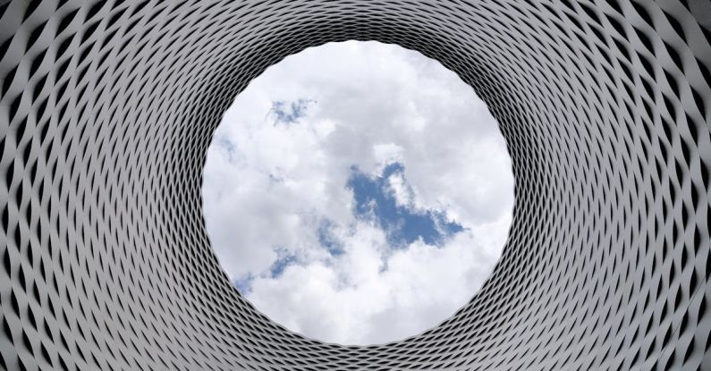 Future Of Mobility - Low-angle Photography of Grey and Black Tunnel Overlooking White Cloudy and Blue Sky